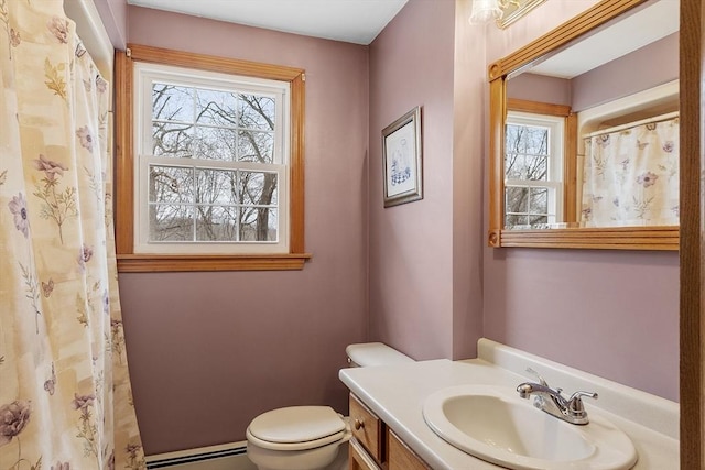 full bath featuring toilet, a baseboard radiator, and vanity