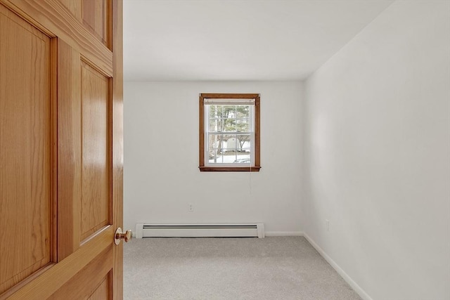 empty room with carpet, baseboards, and baseboard heating