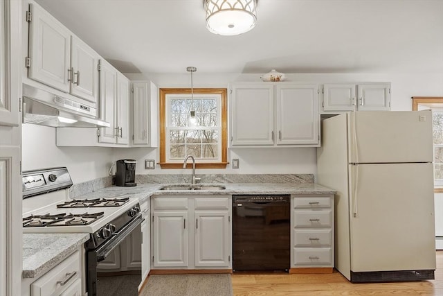 kitchen with black dishwasher, freestanding refrigerator, under cabinet range hood, a sink, and gas stove