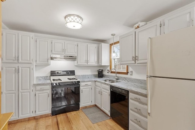 kitchen featuring dishwasher, range with gas cooktop, freestanding refrigerator, under cabinet range hood, and a sink