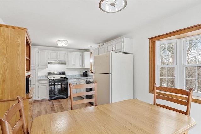 kitchen with dishwasher, freestanding refrigerator, light countertops, under cabinet range hood, and gas stove