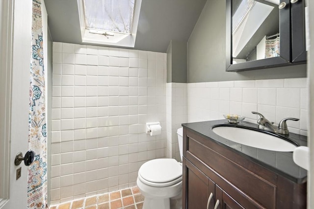 185 Woodland St, Natick, MA 01760 - full bathroom featuring toilet, tile walls, vanity, a skylight, and a shower with shower curtain
