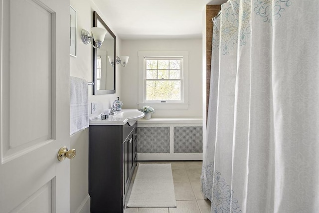 185 Woodland St, Natick, MA 01760 - bathroom with radiator heating unit, vanity, and tile patterned floors