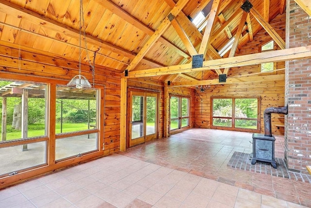 1175 Main Rd, Westport, MA 02790 - unfurnished living room featuring wood walls, wooden ceiling with exposed beams, a wood stove, high vaulted ceiling, and tile patterned flooring