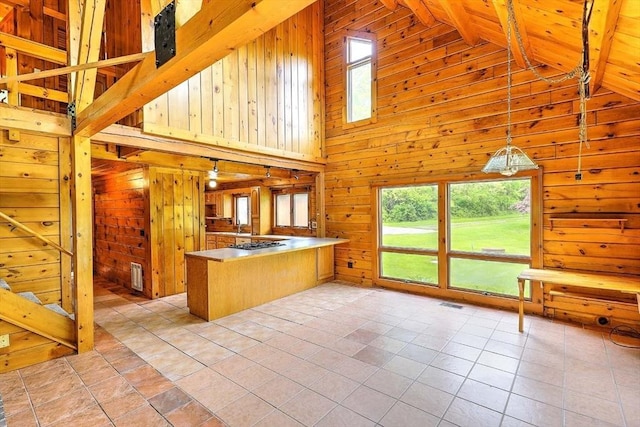 1175 Main Rd, Westport, MA 02790 - kitchen featuring a peninsula, wooden walls, high vaulted ceiling, decorative light fixtures, and light tile patterned flooring