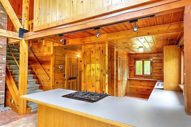 1175 Main Rd, Westport, MA 02790 - kitchen featuring wood walls, black gas cooktop, and wood ceiling with exposed beams