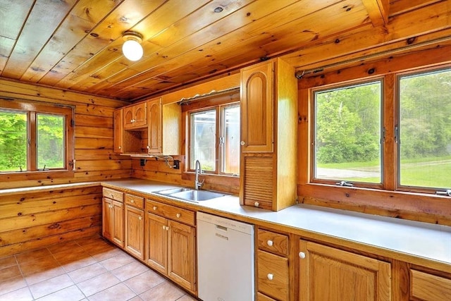 1175 Main Rd, Westport, MA 02790 - kitchen featuring white dishwasher, a sink, healthy amount of natural light, light tile patterned floors, and wooden walls