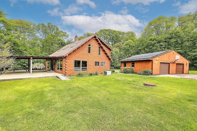 1175 Main Rd, Westport, MA 02790 - rear view of house featuring log siding, a chimney, an outdoor structure, and a yard