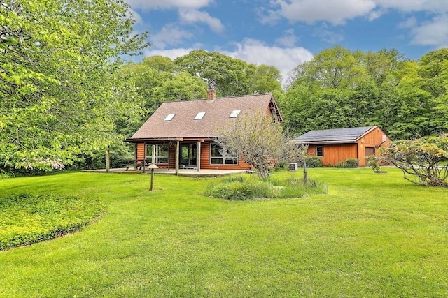 1175 Main Rd, Westport, MA 02790 - back of property featuring a yard, an outdoor structure, a chimney, and a patio
