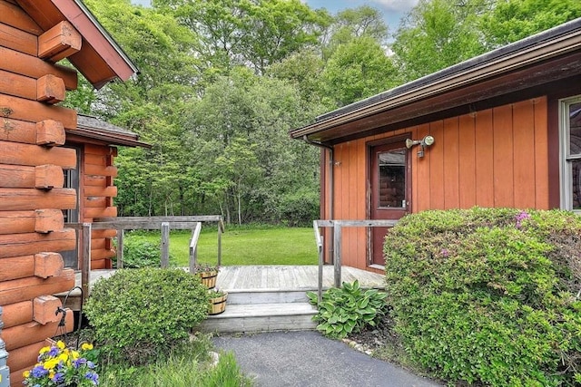1175 Main Rd, Westport, MA 02790 - view of exterior entry with a wooden deck, log exterior, and a lawn