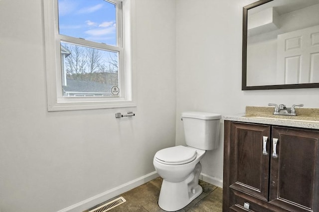 bathroom featuring tile patterned flooring, vanity, and toilet