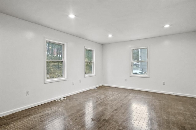 empty room featuring dark hardwood / wood-style flooring