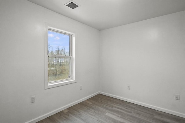 unfurnished room featuring dark hardwood / wood-style flooring