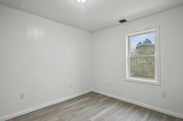 unfurnished room with a wealth of natural light and wood-type flooring