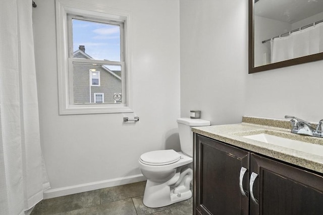 bathroom featuring tile patterned flooring, vanity, and toilet