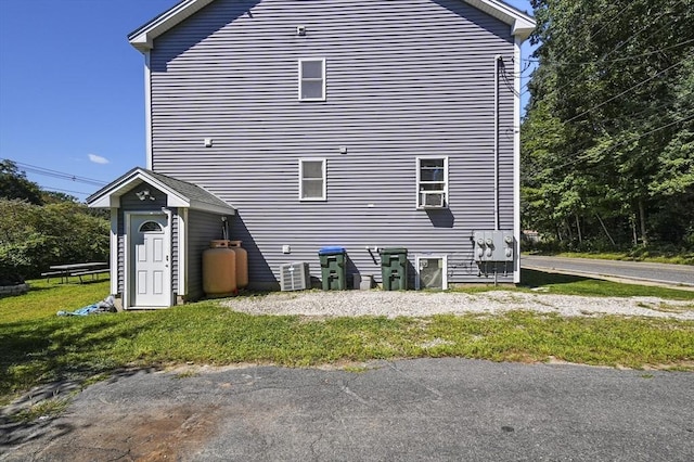 rear view of property featuring a lawn