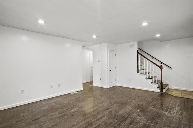 unfurnished living room featuring dark wood-type flooring