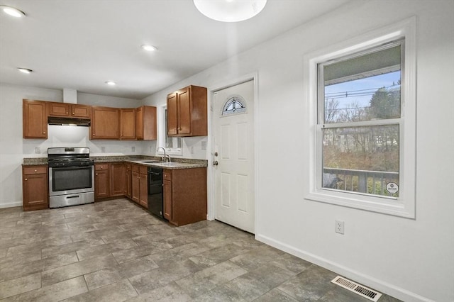 kitchen featuring dishwasher, gas range, and sink