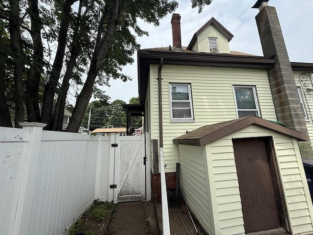 156 Euclid Ave, Lynn, MA 01904 - view of home's exterior featuring a gate and a chimney
