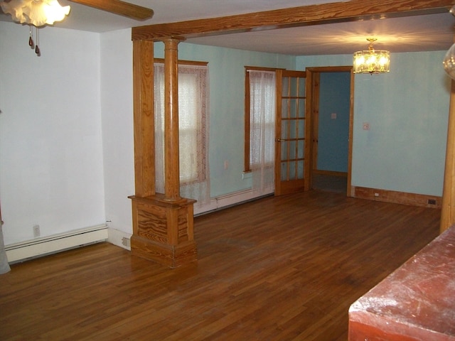 interior space featuring decorative columns, ceiling fan with notable chandelier, dark hardwood / wood-style floors, and a baseboard heating unit