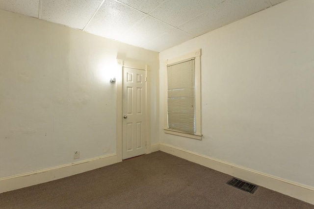 carpeted spare room with a paneled ceiling