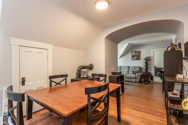 dining space featuring lofted ceiling and light wood-type flooring