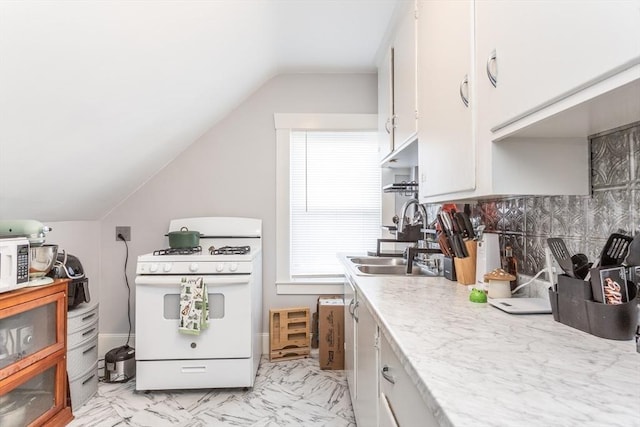 kitchen with white cabinetry, vaulted ceiling, sink, and white range with gas stovetop