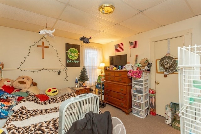 carpeted bedroom with a paneled ceiling