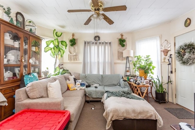 interior space with crown molding, ceiling fan, a healthy amount of sunlight, and carpet flooring