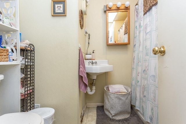 bathroom with tile patterned flooring and toilet