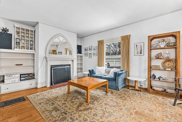 living room with a fireplace and wood finished floors