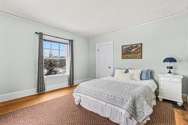 bedroom featuring wood finished floors and baseboards