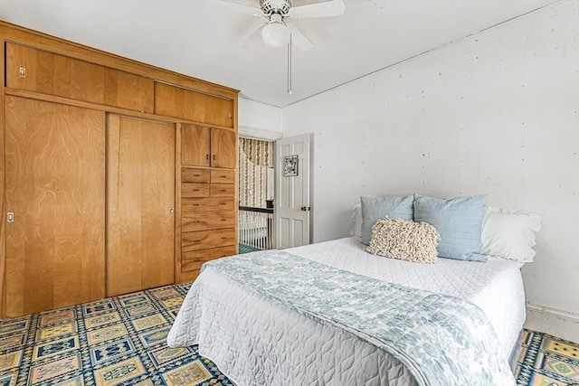 bedroom featuring ceiling fan and a closet