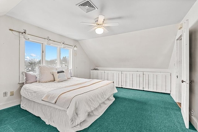 bedroom with baseboards, vaulted ceiling, visible vents, and dark colored carpet