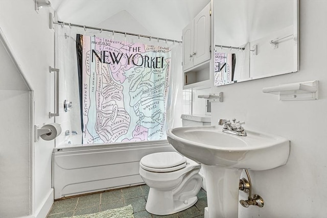 bathroom featuring shower / bath combination with curtain and toilet