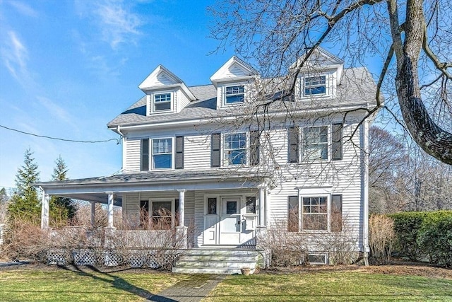 view of front of house with covered porch and a front yard