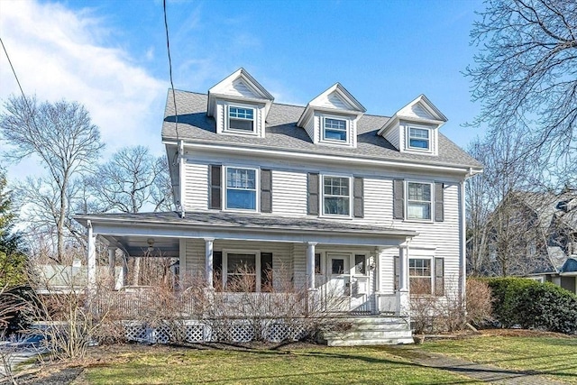 view of front of property featuring a porch, roof with shingles, and a front lawn