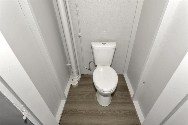 bathroom with wood finished floors and toilet