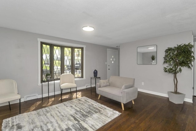 sitting room featuring baseboards and wood finished floors