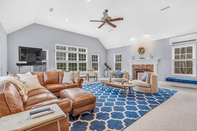 living area with a wall mounted AC, vaulted ceiling, carpet floors, visible vents, and a ceiling fan