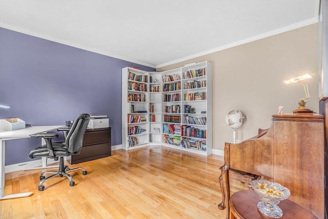 office space with baseboards, wood finished floors, and ornamental molding