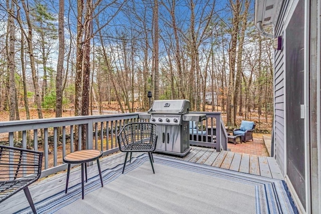 wooden terrace featuring a grill