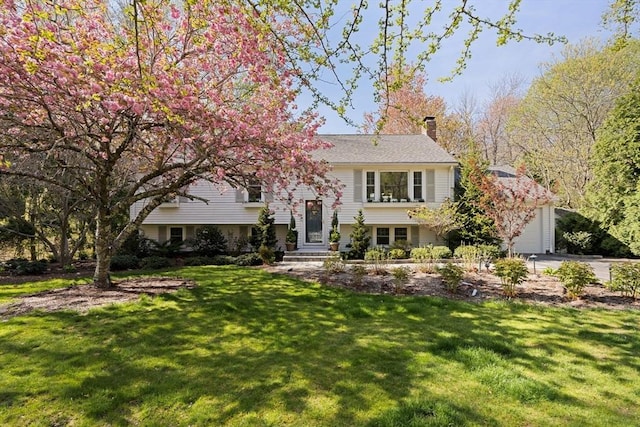 40 Brewster Rd, Cohasset, MA 02025 - split foyer home featuring a chimney, a front lawn, driveway, and entry steps