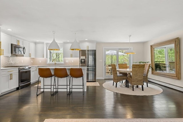40 Brewster Rd, Cohasset, MA 02025 - kitchen featuring stainless steel appliances, backsplash, a center island, white cabinets, and recessed lighting