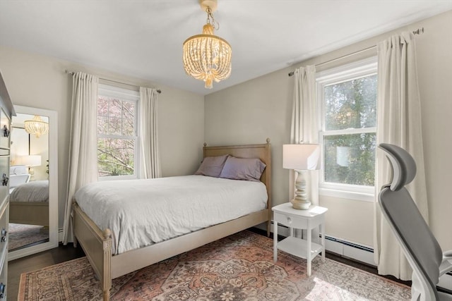 40 Brewster Rd, Cohasset, MA 02025 - bedroom with a chandelier, multiple windows, wood finished floors, and a baseboard radiator