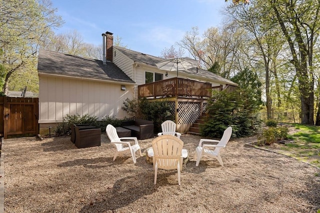 40 Brewster Rd, Cohasset, MA 02025 - rear view of house with stairway, a wooden deck, fence, and a chimney