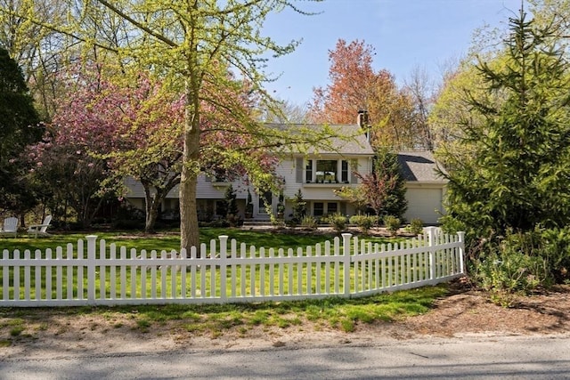 40 Brewster Rd, Cohasset, MA 02025 - obstructed view of property with a fenced front yard, an attached garage, and a chimney