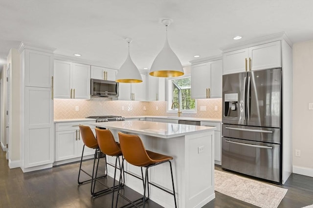 40 Brewster Rd, Cohasset, MA 02025 - kitchen featuring stainless steel appliances, a center island, white cabinetry, and recessed lighting
