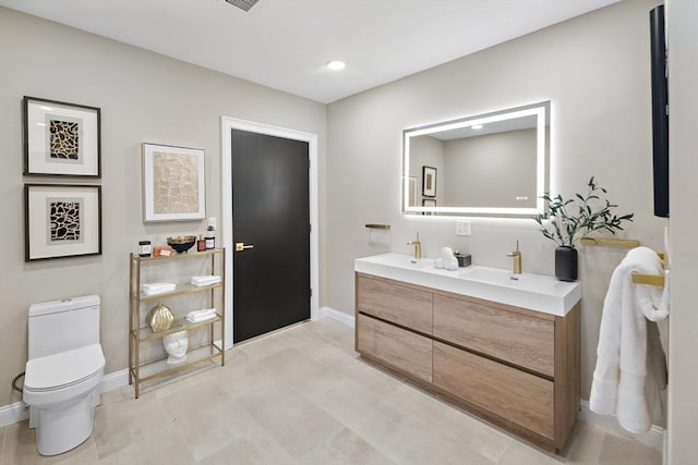 bathroom with vanity and toilet