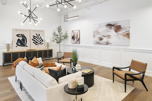 living room with hardwood / wood-style floors and a chandelier